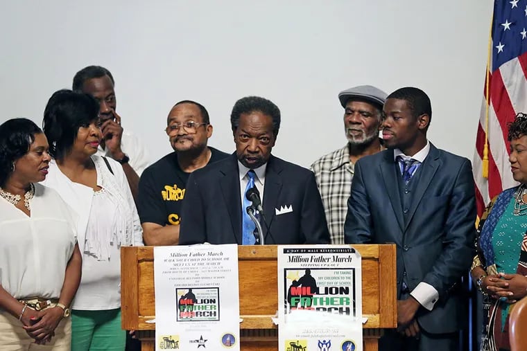 David Fattah (center) and other organizers of the local Million Father March at City Hall to explain the initiative. (DAVID SWANSON/Staff Photographer)
