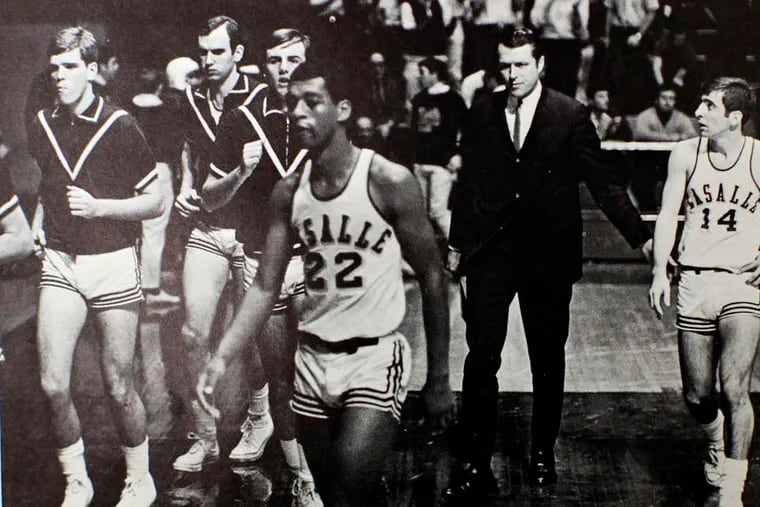 Former Temple and Penn coach Fran Dunphy (14) playing for Tom Gola (in suit) at La Salle in 1968-69.