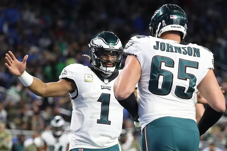 Philadelphia Eagles quarterback Jalen Hurts (left) celebrates with offensive tackle Lane Johnson (right) after they scored in the third quarter. Philadelphia Eagles win 44-6 over the Detroit Lions at Ford Field in Detroit, Mich. on October 31, 2021.