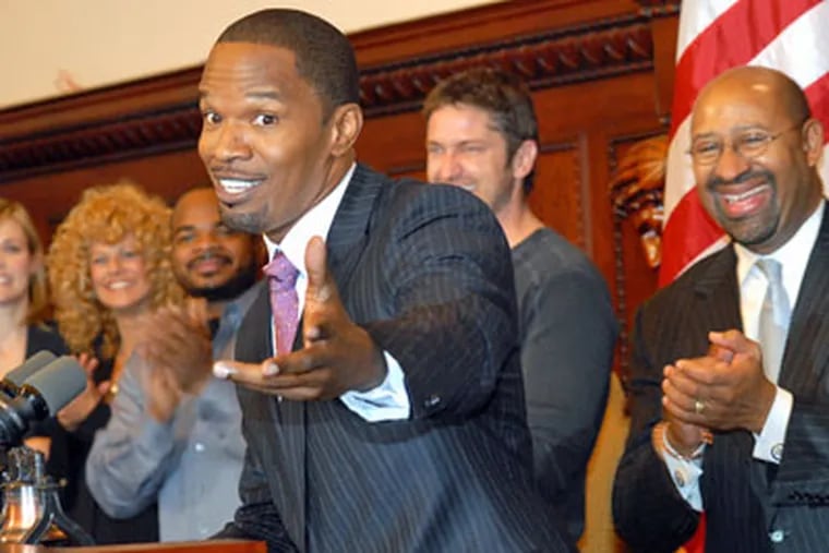 Jamie Foxx, who stars in the film "Law Abiding Citizen," now shooting in Philadelphia, addresses the media, after cast and crew were given a Liberty Bell award; also in photo, from left to right, are actress Leslie Bibb; Sharon Pinkenson; director F. Gary Gray; actor Gerard Butler, and Mayor Michael Nutter. (April Saul / Staff Photographer)
