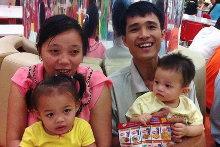 Vu The Phong (right) shown with his family, will visit Philly. (FAMILY PHOTO)