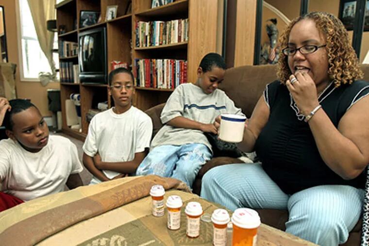 Charmaine Humphrey, who is uninsured and takes six medications daily, is on the waiting list for adultBasic. With her are (from left) son Qu-Ran Mosley, 11; nephew Jaime Galarza, 14, and son Danny Allen Jr., 9. (Akira Suwa / Staff Photographer)