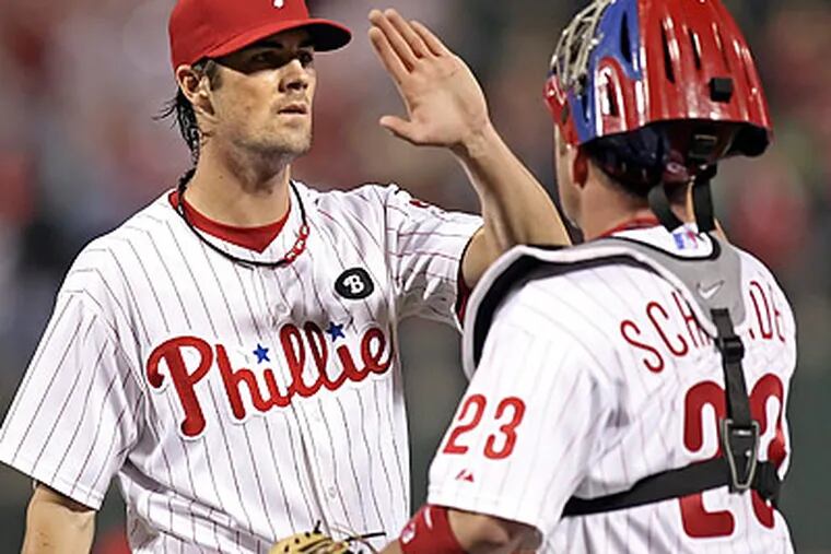 Cole Hamels celebrates with Brian Schneider after wrapping up a complete-game win. (Steven M. Falk/Staff Photographer)