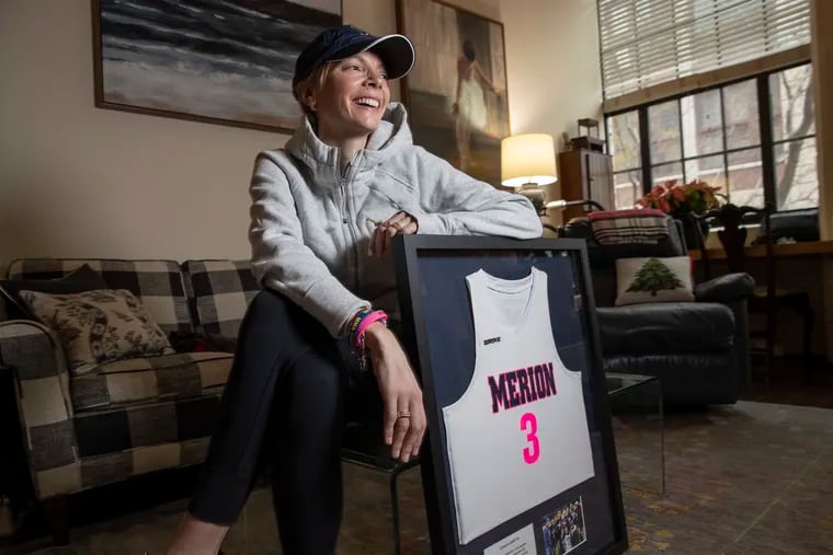 Merion Mercy field hockey coach Gretta Ehret with the framed Merion field hockey jersey she was given at the end of the year awards banquet to commemorate her many victories as coach of the team. She coached this season while undergoing treatment for breast cancer.