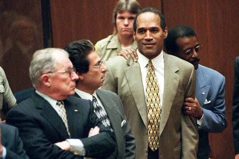 In this Oct. 3, 1995, photo, attorney Johnnie Cochran Jr. holds O.J. Simpson as the not guilty verdict is read in a Los Angeles courtroom during his trial in Los Angeles. Defense attorneys F. Lee Bailey (left) and Robert Kardashian look on. Simpson, the decorated football superstar and Hollywood actor who was acquitted of charges he killed his former wife and her friend but later found liable in a separate civil trial, has died. He was 76.