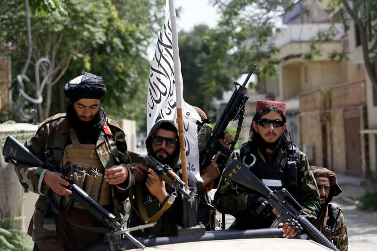 Taliban fighters displayed their flag and weapons while on patrol in Kabul, Afghanistan, in August. A coalition of Afghan and legal groups in the United States say the Biden administration must do more to help endangered Afghans, many of whom assisted U.S. forces, get out of the country.