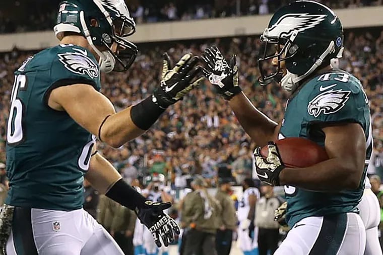 Darren Sproles celebrates a touchdown with Zach Ertz against the Carolina Panthers. (David Maialetti/Staff Photographer)