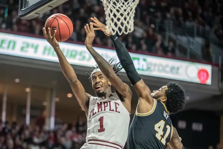 Temple guard Quinton rose, left, drives for layup over the defense of Villanova forward Saddiq Bey, right, in the second half of their game at the Liacouras Center on February 16, 2020.  Villanova won 76-56. .