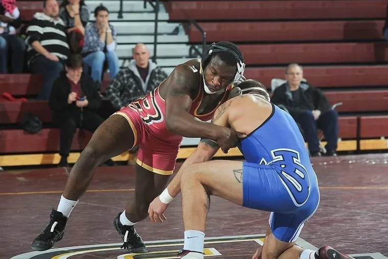 Rich Perry, left, was a standout wrestler for Bloomsburg University. He is suing the United States Marine Corps after suffering a bizarre and traumatic head injury at a California base last year.