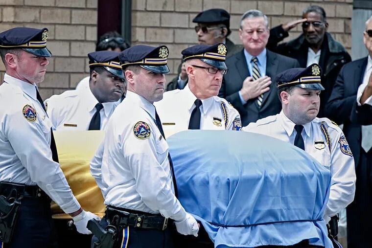 Former Philadelphia Police Commissioner Willie L. Williams’ casket is carried by a police honor
guard. The casket is draped in the flag of Philadelphia.