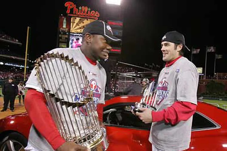 Ryan Howard holds the World Series trophy and Cole Hamels holds the MVP trophy after the Phillies won game 5 of the World Series.  (Barbara L. Johnston / Staff Photographer)