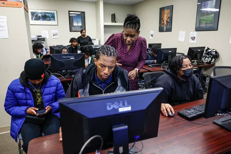 PYN CEO Wendy-Anne Roberts-Johnson has a new vision for teen employment, shown here helping to fill out applications for the program with Samir Williams 16. Tuesday, April 2, 2024