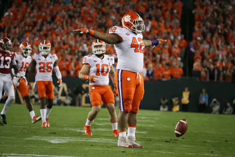 Clemson Tigers defensive lineman Christian Wilkins (42) celebrates breaking up a pass from Alabama Crimson Tide quarterback Jalen Hurts during the first quarter of the College Football Playoff National Championship on Monday, Jan. 9, 2017 at Raymond James Stadium in Tampa, Fla. (Monica Herndon/Tampa Bay Times/TNS)