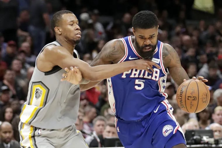 The 76ers' Amir Johnson (5) drives past Cleveland’s Rodney Hood in the second half.