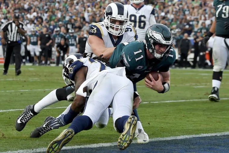 Carson Wentz gets tackled during the third quarter. He left the game shortly after the play and did not return.