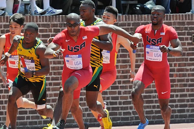 Team USA's Walter Dix takes the hand-off from Rakieem Salaam to defeat
Jamaica in the 4 x 100 USA vs the world event at the Penn Relays. (Ron Tarver/Staff Photographer)