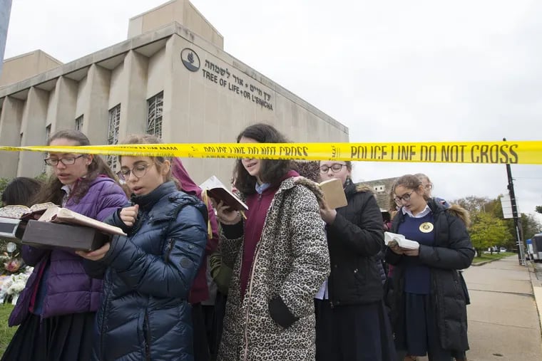 Girls from the Yeshiva School of Pittsburgh gather to sing and pray outside of the Tree of Life Synagogue in Pittsburgh on Monday, Oct. 29, 2018, two days after 11 people were fatally shot inside.
