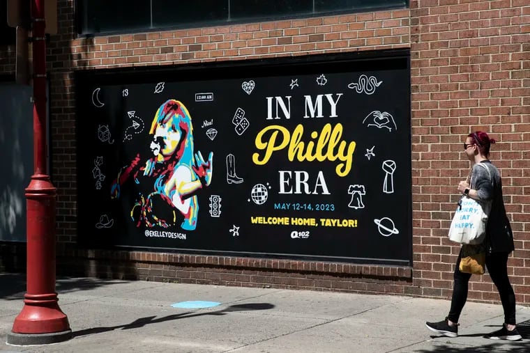 Pedestrians walk past the Taylor Swift mural by Emily Kelley near 2nd and South Streets in Philadelphia, Pa. on Wednesday, May 10, 2023. Taylor Swift performs in Philly this weekend.