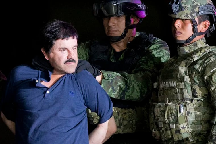 FILE - In this Jan. 8, 2016 file photo, a handcuffed Joaquin "El Chapo" Guzman is made to face the press as he is escorted to a helicopter by Mexican soldiers and marines at a federal hangar in Mexico City. Guzman was tried in New York and found guilty on drug smuggling charges. Claims of jury misconduct arose after a juror told VICE News in February 2019 report that several jurors followed media accounts of the three month-long trial. (AP Photo/Eduardo Verdugo, File)