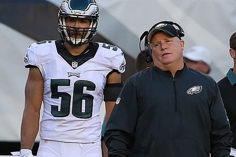 Eagles head coach Chip Kelly (right) looks on as the Eagles were penalized.