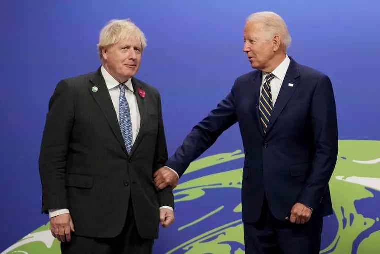 British Prime Minister Boris Johnson, left, greets U.S. President Joe Biden at the COP26 U.N. Climate Summit in Glasgow, Scotland.
