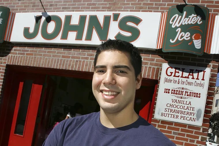 Owner Anthony Cardullo, Jr. hold cherry and chocolate water ices, no spoons, at John's Water Ice at 7th and Christian streets. (R. Kennedy photo)
