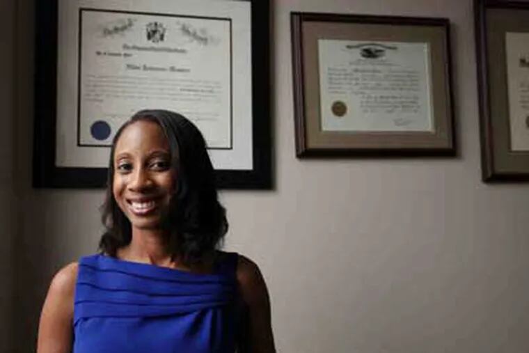 The diplomas in Johnson-Huston's office testify to her determination: She earned three degrees four 4 years. (Jessica Griffin / Staff Photographer)