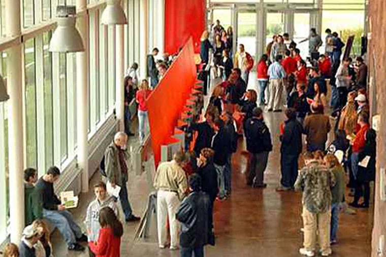 In this file photo from 2009, prospective students and their parents wait for the start of an information session at the new $7 million plus Rutgers University Visitor Center. (Tom Gralish / File)