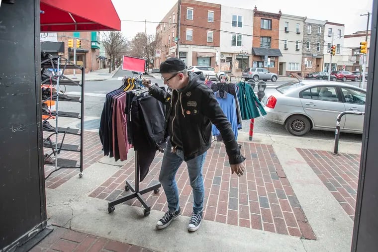 Bob Taylor, owner of "A Mans Image Clothing Store" at Passyunk Avenue and 13th Street pulls in his display of mens pants off the sidewalk and into the store as he closes up shot at 5:00 pm on Monday in compliance with Philadelphia Mayor Jim Kenney's directive that all non-essential businesses have to close due to the coronavirus. Taylor has worked in the shop for 35 years and for the last three years he is the owner.  "This is the worst I have ever seen it"  Taylor said, "This past week we have had only a handful of sales, one on Saturday and two today."