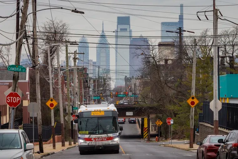 A SEPTA bus on North 17th Street at Sedgley Avenue in March, with the Philadelphia skyline in the background.