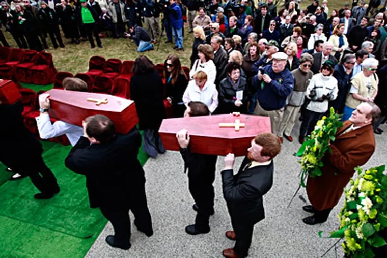 The remains of the Duffy's Cut workers are given a Christian burial at West Laurel Hill Cemetery. They were among 57 Irish immigrants buried in a mass grave in Chester County, dead from disease and possibly murder, say researchers. (David Swanson / Staff Photographer)
