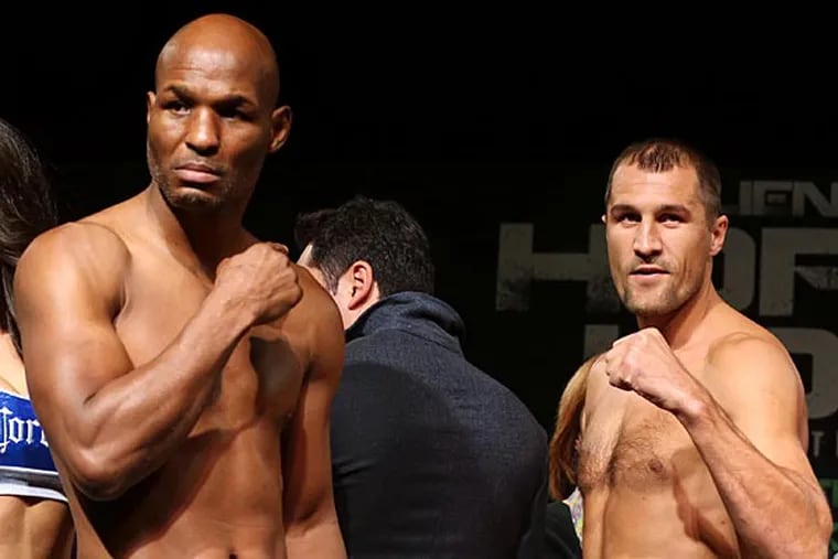 Bernard Hopkins, left, and Sergey Kovalev, right, pose after a weigh-in at Caesars Atlantic City Palladium Ballroom, Friday, Nov. 7, 2014. Hopkins and Kovalev are to meet in a 12-round light-heavyweight title unification bout in Atlantic City on Saturday. (AP Photo/The Press of Atlantic City, Edward Lea)