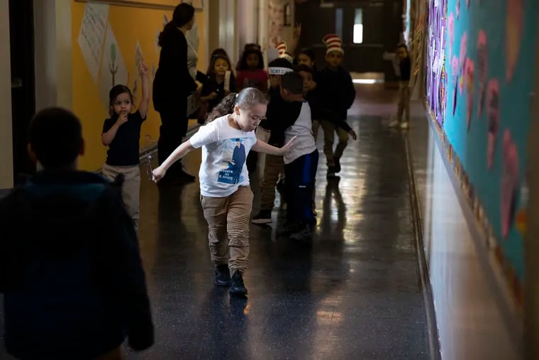 Luis Rivera dances down the hallway at  in West Kensington's Isaac A. Sheppard School, which has low teacher turnover.
