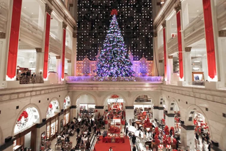 In Macy's atrium, the renowned light show glimmers above holiday shoppers, as it has for decades. (Laurence Kesterson / Staff Photographer)