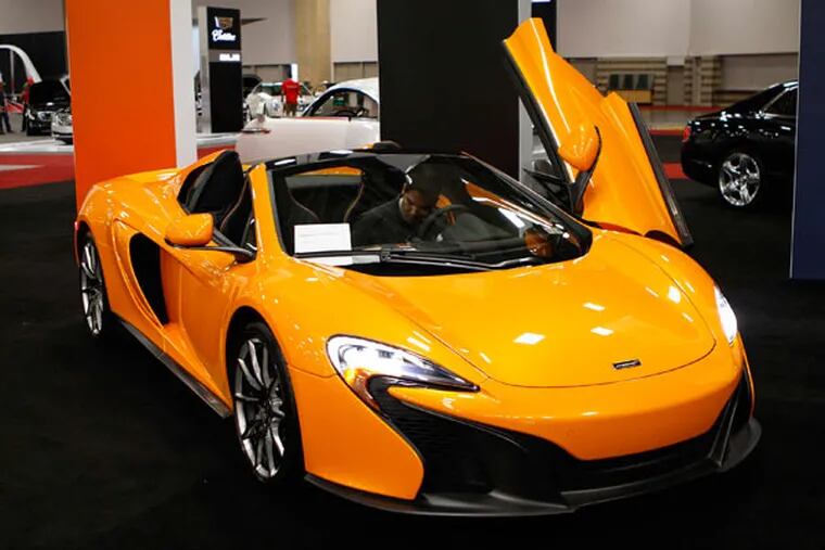 Isaac Villarreal parks a McLaren MSO 650S, which is priced starting at $280,225, in the High End section of the 2015 DFW Auto Show in Dallas on Monday, March 23, 2015. (Jim Tuttle/Dallas Morning News/TNS)