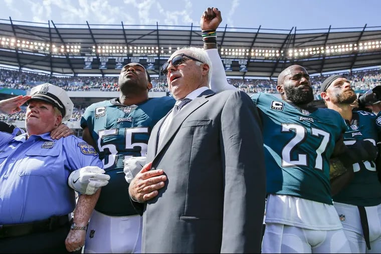 Eagles owner Jeffrey Lurie stands with Eagles defensive end Brandon Graham and strong safety Malcolm Jenkins during the National Anthem before the Eagles play the New York Giants on Sunday, September 24, 2017 in Philadelphia YONG KIM / Staff Photographer