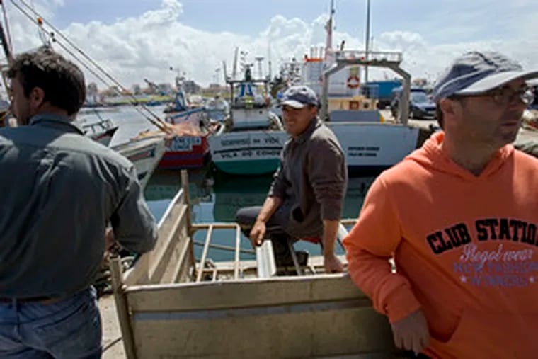 On the first day of their strike, fishermen stand by their boatsat Povoa de Varzim&#0039;s fishing harbor in Portugal. The rising costs of diesel fuel in Europe have sparked their move.