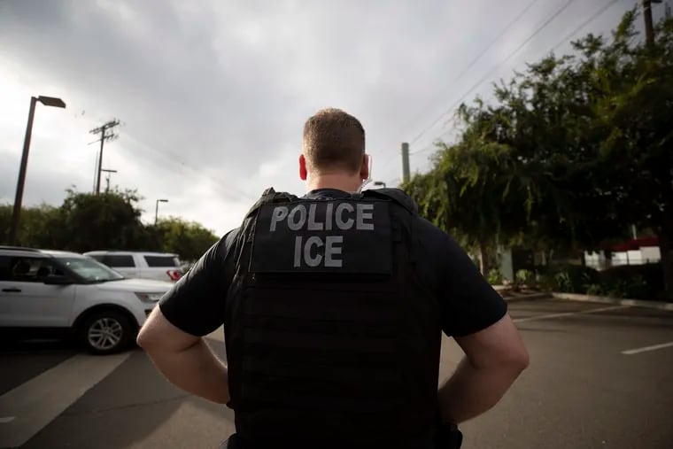 A U.S. Immigration and Customs Enforcement officer looks on during an operation in Escondido, Calif., near San Diego in July 2019.