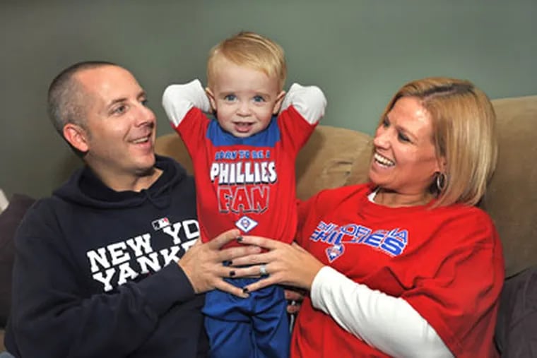 Stephen Rupprecht, originally from Long Island, is a Yankees fan. His wife Sharon, from Lafayette Hill, is a Phillies fan. Their son Matthew, 18 months, is a Phillies fan because of a previous bet. Sharon is expecting and the new baby will become a fan of whichever team wins the series. ( Sharon Gekoski-Kimmel / Staff Photographer )