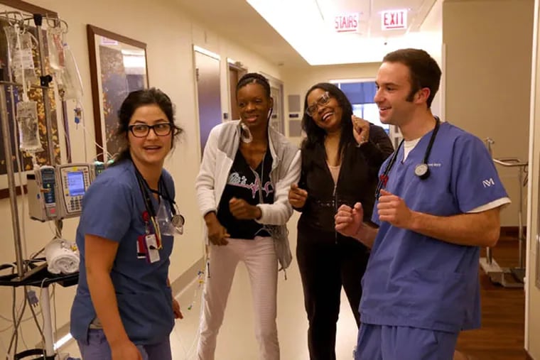 Nurses Shira Blanton, left, and Karl Kettlehut dance for a video with Niki Glass, left, and Karen Tompkins on Jan. 26, 2015 at Northwestern Medical Center in Chicago. Some of the heart patients wanted to make a video dancing to "Happy" by Pharrell Williams, and Niki and Karen helped out by participating. Glass, 37, and Tompkins, 52, became "heart sisters" at Northwestern Medical Center in Chicago where they were both waiting for heart transplants. (Nancy Stone/Chicago Tribune/TNS)