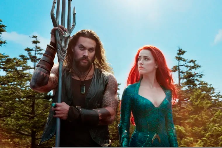 This image released by Warner Bros. Pictures shows Jason Momoa, left, and Amber Heard in a scene from "Aquaman." (Warner Bros. Pictures via AP)