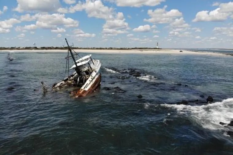 The Coast Guard is monitoring the fishing vessel Bay of Isles for potential pollution after it ran around at the Barnegat Inlet Jetty in N.J. and two fishermen were hoisted to safety.