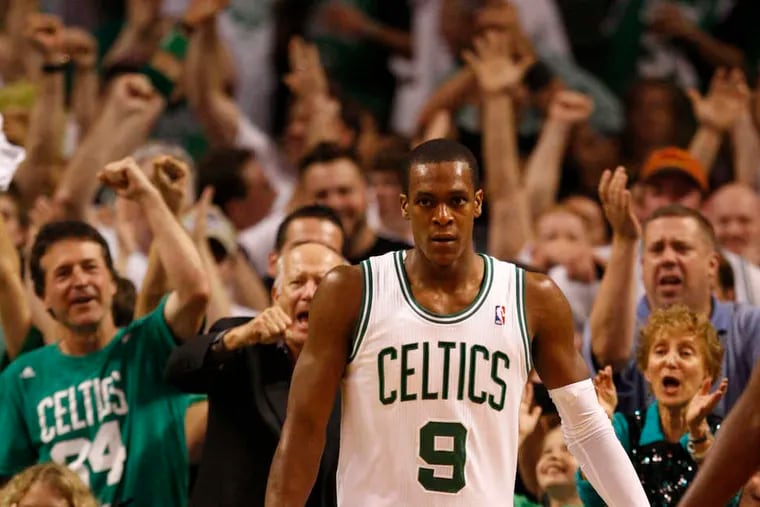 Agony and ecstasy in Game 7: Above, the Sixers' Lou Williams (left) and Jrue Holiday are glum after a Celtics basket put Boston ahead in the second quarter. Below, guard Rajon Rondo brings Celtics fans to their feet after a basket.