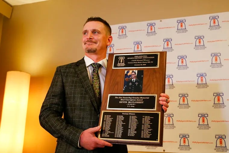 Former U.S. Army Corporal Kevin McCloskey holds the Philadelphia Sports Writers Association Most Courageous plaque after meeting the media on Monday.