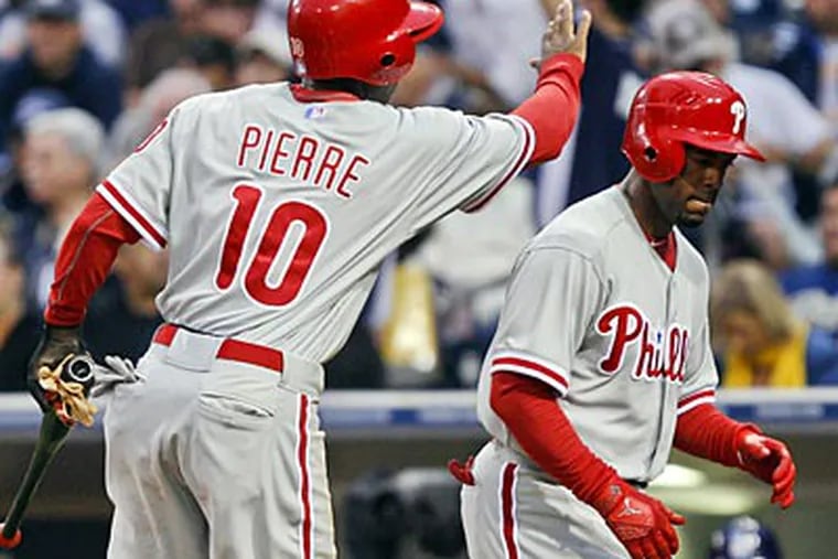 Jimmy Rollins knocked in Juan Pierre with a sacrifice fly in the first inning against the Padres. (Lenny Ignelzi/AP)