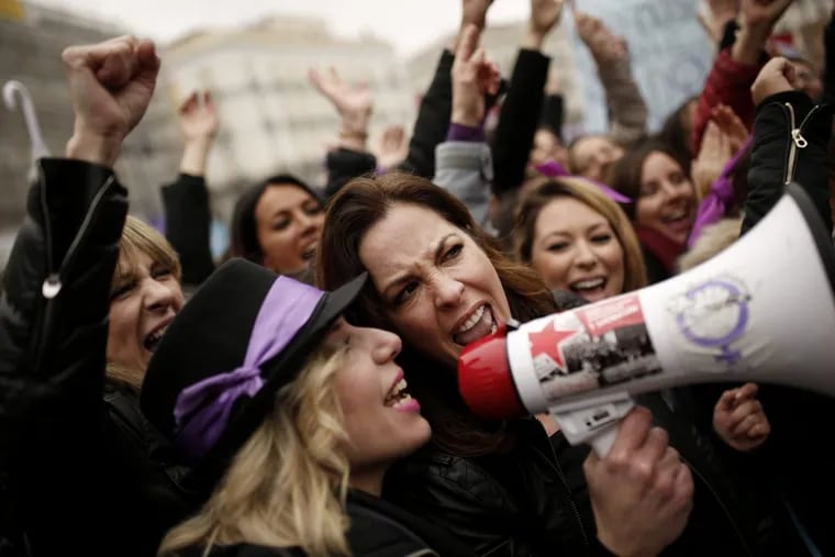 People, mostly women, shout slogans during a protest at the Sol square during the International Women's Day in Madrid, Thursday, March 8, 2018. Spanish women are marking International Women's Day with the first-ever full day strike and dozens of protests across the country against wage gap and gender violence. (AP Photo/Francisco Seco)