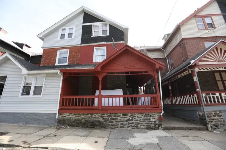 The property with the red porch, 240 Earlham Terrace in Germantown, was operating as an unlicensed group home for intellectually disabled men until officials from the Pennsylvania Department of Human Services removed the men on Feb. 25, seven weeks after a non-disabled resident there notified the state's Adult Protective Services Program.