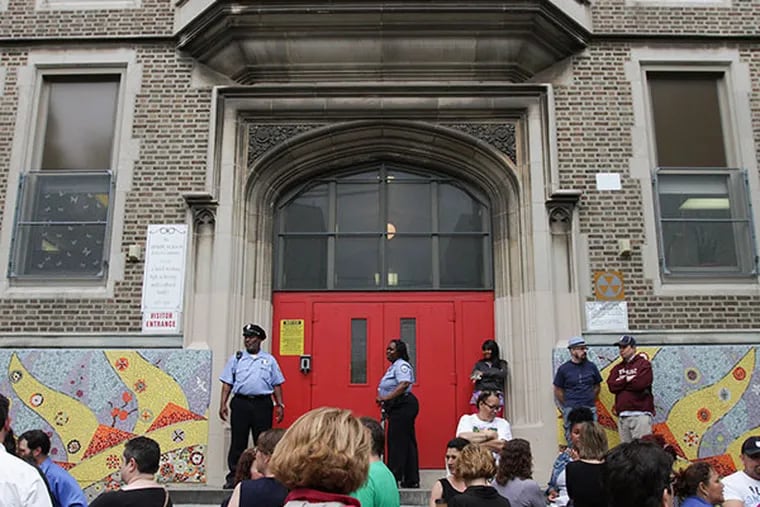 Friends of Jackson School gather outside the Andrew Jackson Elementary School on May 22, 2014. An unidentified first-grader died after becoming ill at school in South Philadelphia on May 21. ( DAVID MAIALETTI / Staff Photographer )