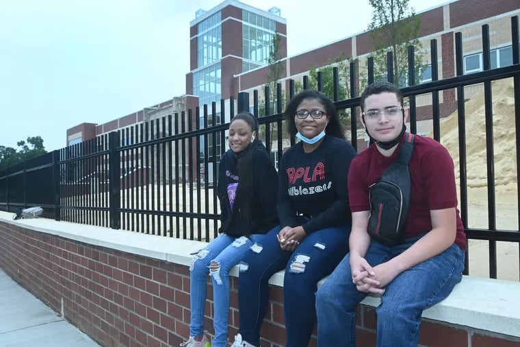 (From left) Zinasia Jackson, of Camden High; Takayla Williams, BPLA; and Lewis Echevarria, Creative Arts, in front of the new Camden High School construction project.