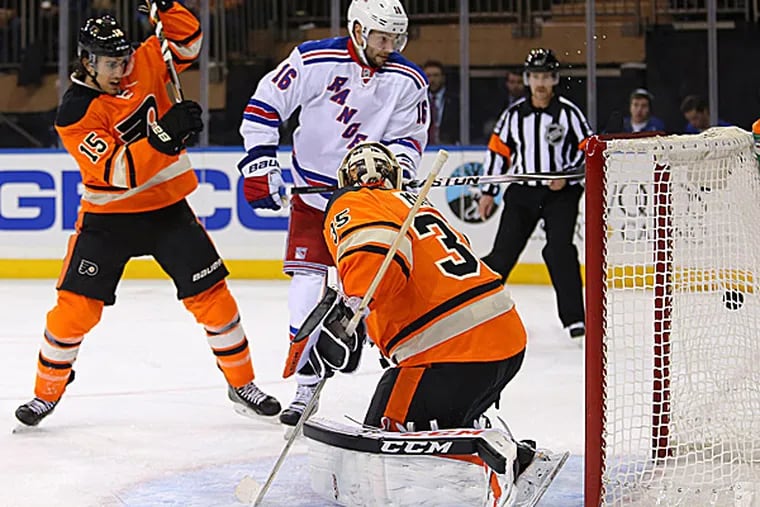 Flyers goalie Steve Mason is unable to make a save during the first period. (Adam Hunger/USA Today Sports)